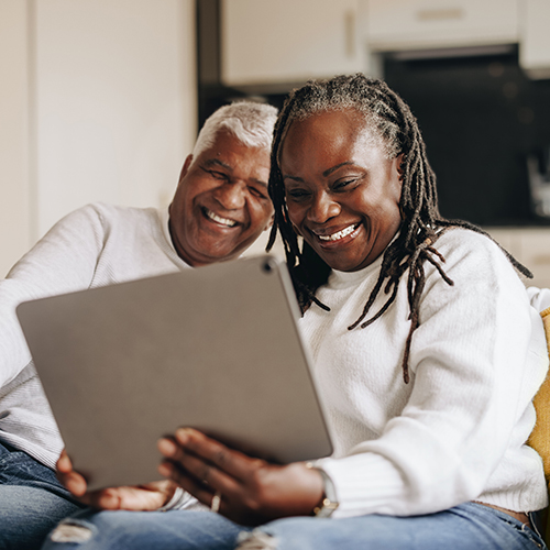 An older couple looking at a laptop screen